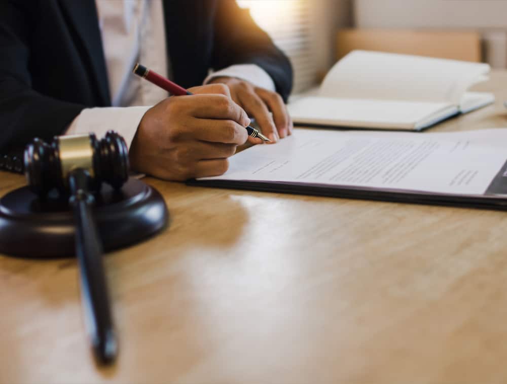 a person using a laptop computer sitting on top of a wooden table
